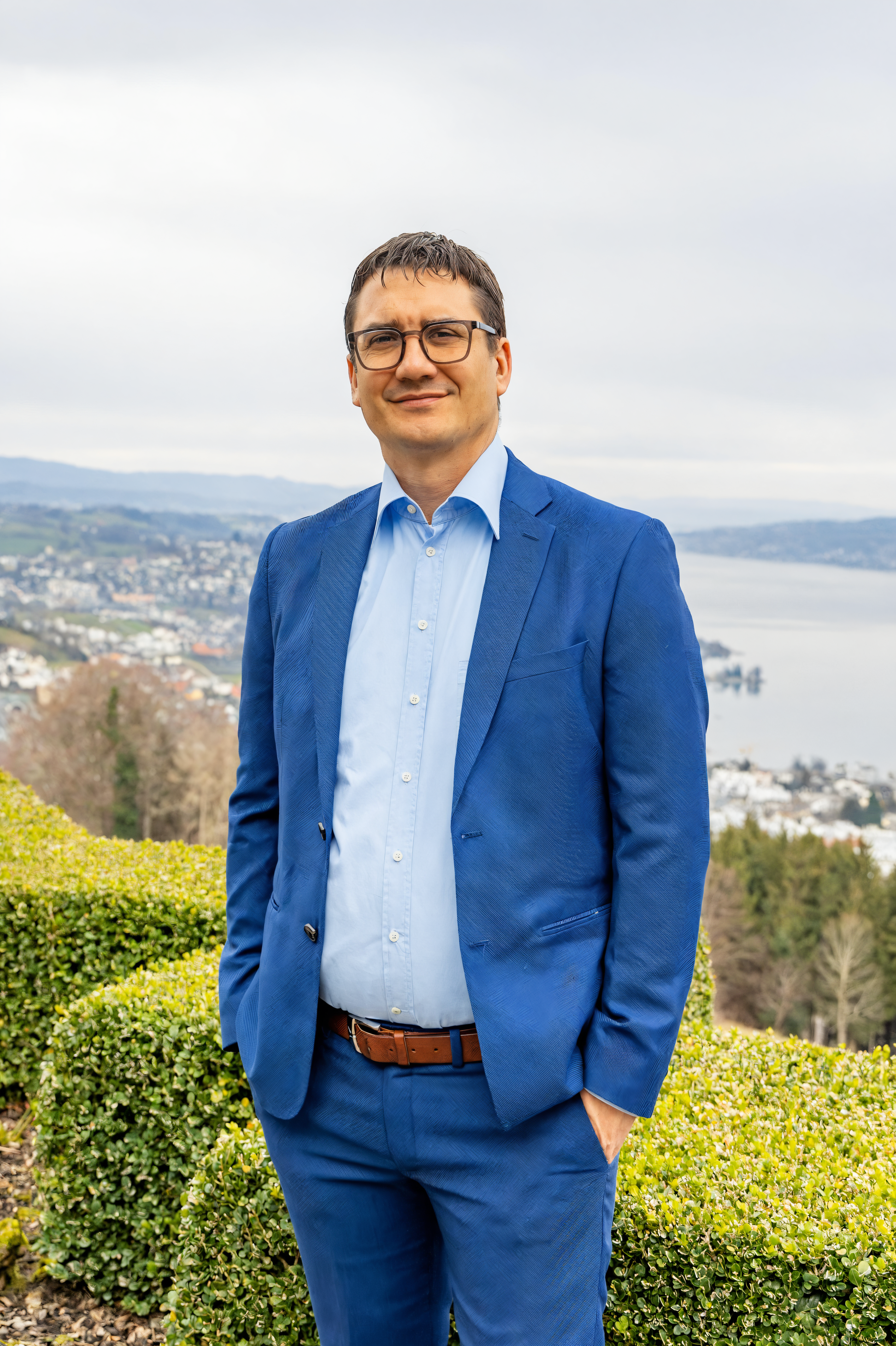 Experience the transformative power of Stable Assistant's Upscale tool, which elevates your images to new heights while maintaining their original essence. In this stunning example, a man in a sharp blue suit stands confidently against a breathtaking backdrop of a cityscape and water, showcasing the tool's ability to enhance clarity and detail effortlessly.