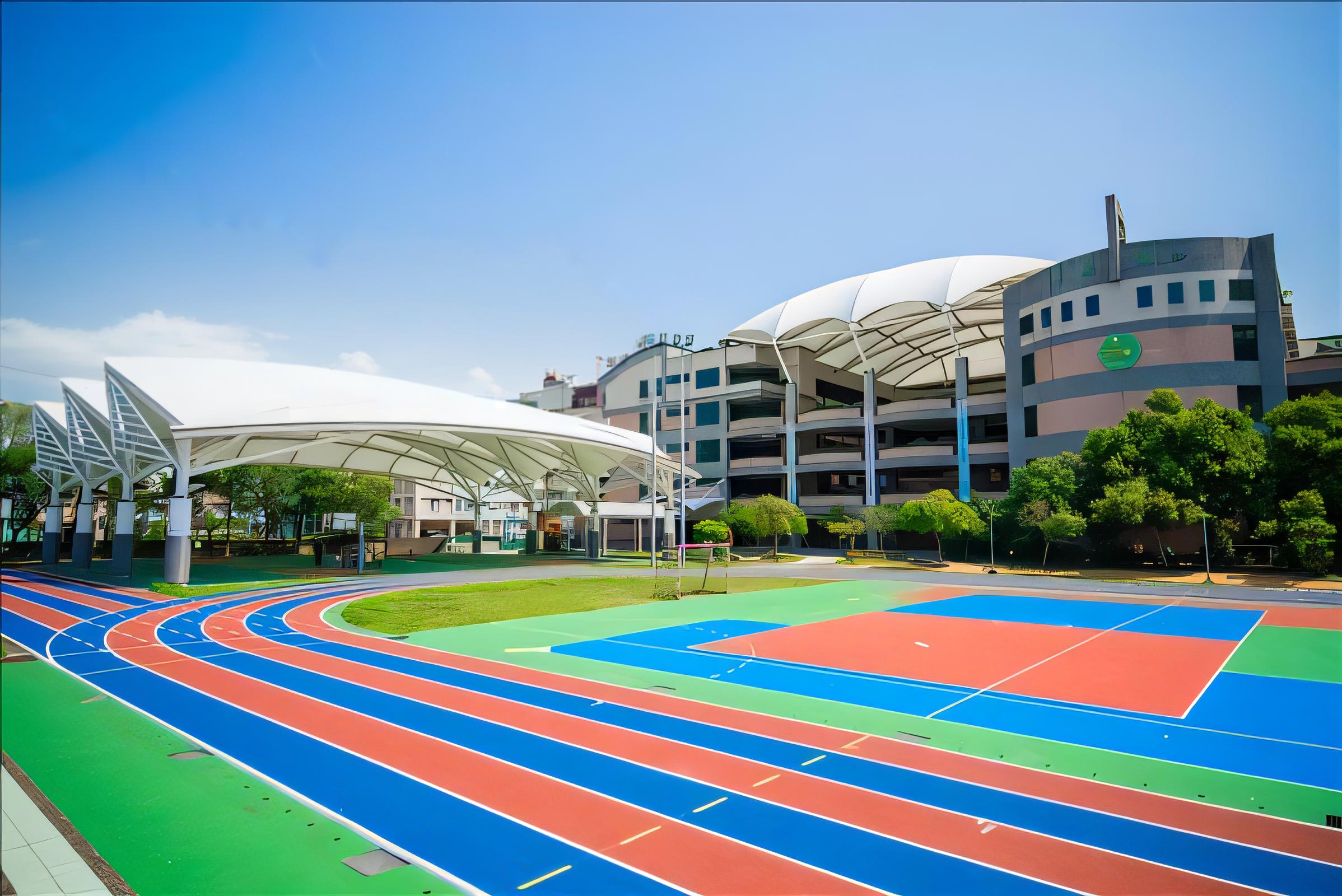 The image showcases a vibrant outdoor sports facility with a multi-lane track and a colorful basketball court, all set against a backdrop of modern buildings. The 'Erase' tool has been used to remove any unwanted elements, enhancing the focus on the clean, well-maintained facilities. This image highlights the capabilities of 'Erase' in creating a clutter-free visual, ideal for promoting sports and leisure activities in a contemporary urban setting.